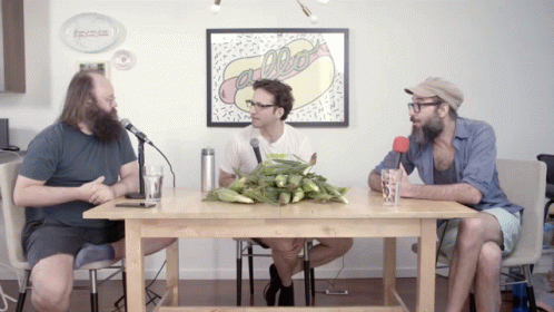 Three Men at Table with Hot Dog Picture