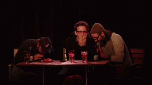 Three Men at Table With Yellow Unscoop Text