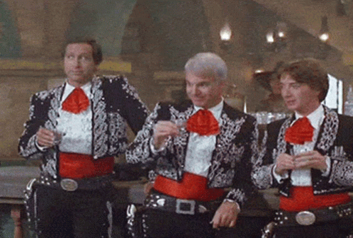 Three Men Dressed as Mariachis Drinking