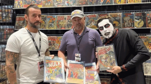 Three Men Holding Hulk Comic Book