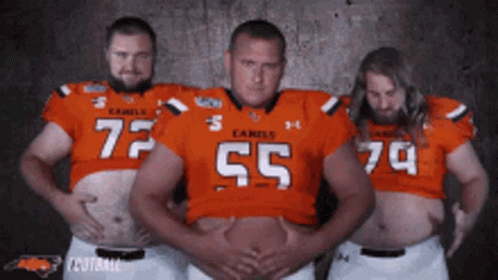 Three Men In Camels Football Jerseys Posing GIF