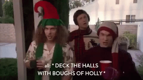 Three Men In Christmas Costumes On Porch GIF