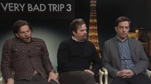 Three Men in Front of Bad Trip 3 Sign
