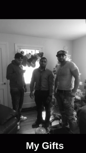 Three Men In Front Of Christmas Tree Saying My Gifts GIF