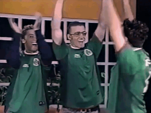 Three Men in Green Shirts Number 2 Raising Arms