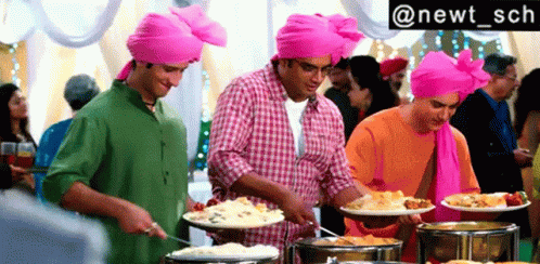 Three Men In Pink Turbans Serving Buffet Food GIF