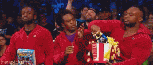 Three Men In Red Jackets Holding Popcorn GIF