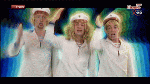 three men in sailor hats are dancing in front of a screen that says ' history ' on it