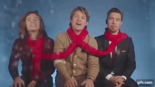 Three Men in Scarves Sitting Together