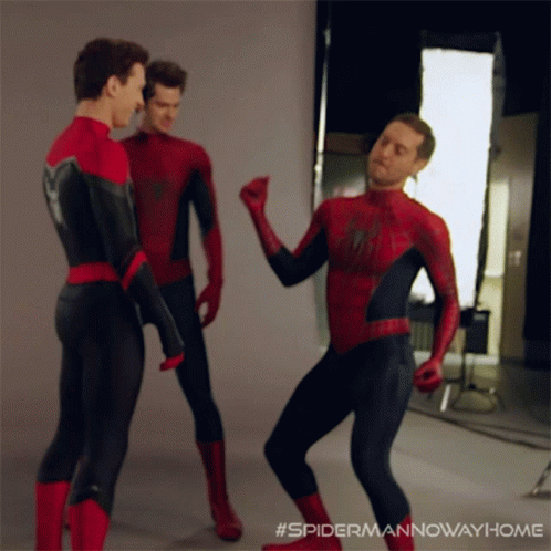 Three Men In Spider-Man Costumes Are Dancing Together GIF