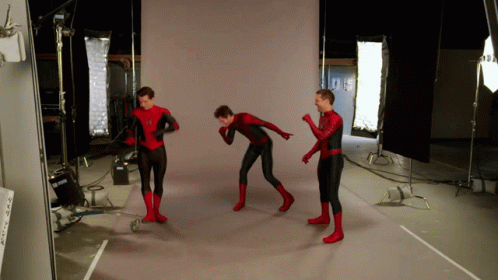 Three Men In Spider Man Costumes Are Standing In A Room GIF