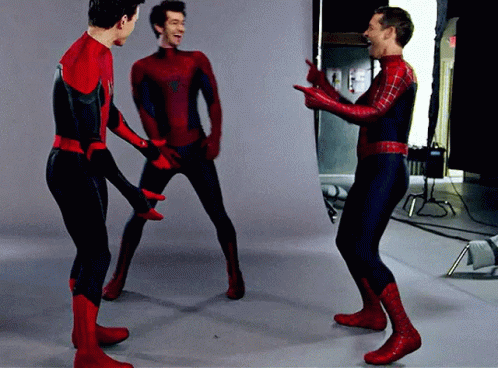 Three Men In Spiderman Costumes Are Standing In A Room GIF
