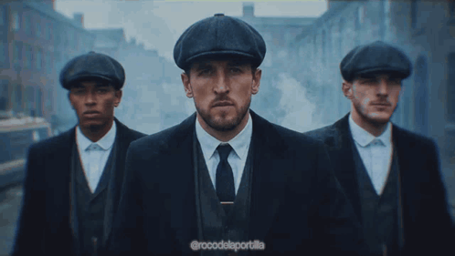 Three Men In Suits And Hats Are Walking Down A Street With The Caption @Rocodelaportalla GIF