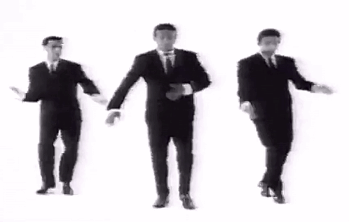 Three Men In Suits And Ties Are Dancing Together In A Black And White Video . GIF
