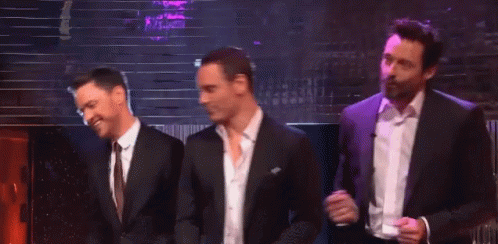Three Men In Suits And Ties Are Dancing Together On A Stage GIF