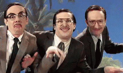 Three Men In Suits And Ties Are Making Funny Faces In Front Of A Blue Sky . GIF