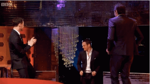 Three Men In Suits Are Dancing On A Stage With Bbc Written On The Bottom Right GIF