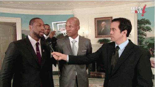 Three Men in Suits With Let's Move On Wall