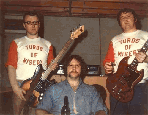 Three Men In Turds Of Misery Shirts GIF