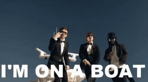 Three Men In Tuxedos Are Standing Next To Each Other With The Words I 'M On A Boat Written In White GIF