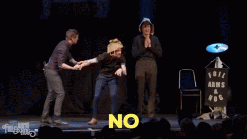 Three Men On Stage With The Words Let Him Die In Agony GIF
