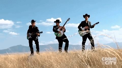 Three Men Playing Guitars in Field