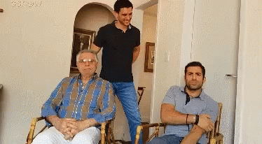 Three Men Posing One Wearing Glasses