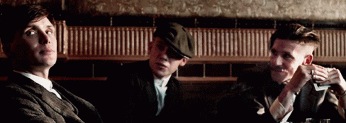 Three Men Sitting At Table One Smoking GIF