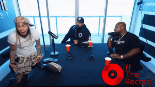 Three Men Sitting at Table with ff the Record