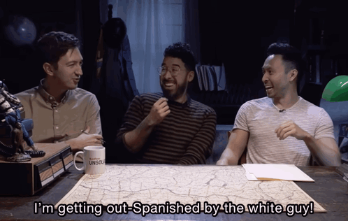 Three Men Sitting At Table With Mug I'm Getting Out-Spanish By The White Guy GIF