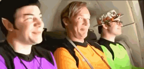 Three Men Sitting in Back Seat of Plane