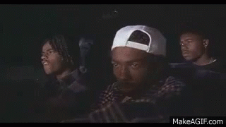 Three Men Sitting in Car Watching Movie One With White Hat