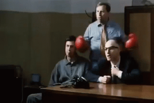Three Men Sitting with Boxing Gloves
