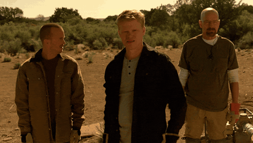 Three Men Standing In A Desert With One Wearing A T-Shirt That Says ' Abercrombie & Fitch ' On It GIF