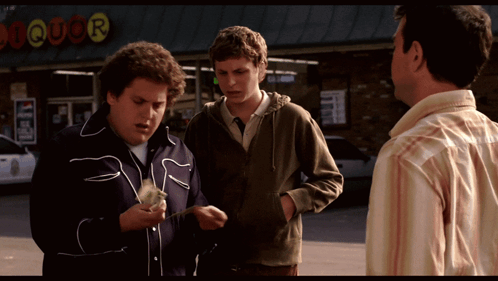 Three Men Standing In Front Of A Liquor Store Talking GIF