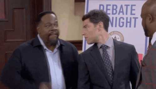 Three Men Standing In Front Of Debate Sign GIF