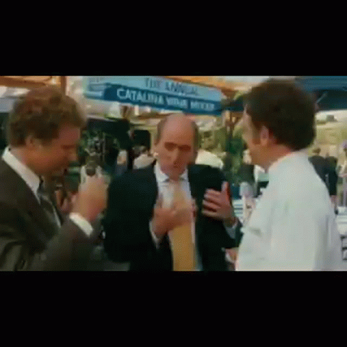 Three Men Standing in Front of Sign Saying Annual Catalina Wine Mixer