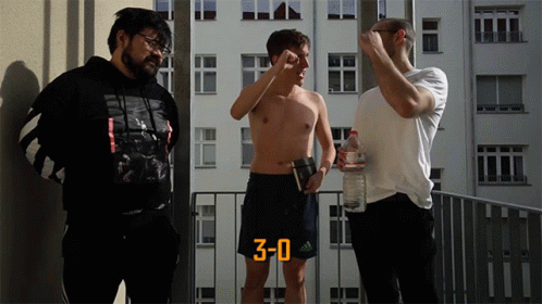Three Men Standing on Balcony with Number 3 Shorts