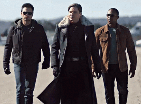 Three Men Standing Together On Dirt Road GIF