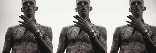 Three Men With Tattoos On Their Bodies Are Standing Next To Each Other With Their Hands On Their Faces GIF