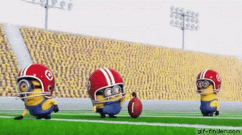 Three Minions Are Playing Football On A Field Wearing Helmets And Holding A Ball . GIF