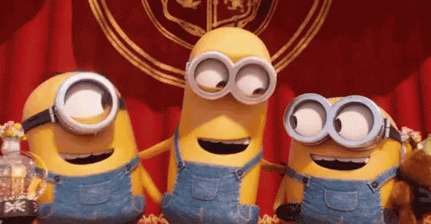 Three Minions in Overalls and Goggles Standing Together