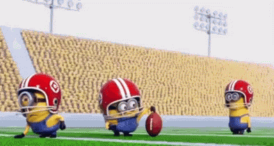 Three Minions Playing Football Wearing Helmets Holding Football GIF