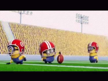 Three Minions Wearing Football Helmets Are Running On A Field With A Ball GIF