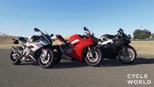 Three Motorcycles Are Parked Next To Each Other With Cycle World Written On The Bottom Right GIF