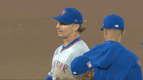 Three New York Mets Baseball Players Are Standing On The Field GIF
