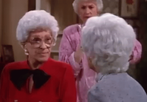 Three Older Women Are Standing Next To Each Other In A Living Room Talking To Each Other . GIF