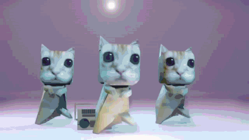 Three Origami Cats Are Standing Next To Each Other On A White Surface GIF