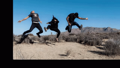 Three People Are Jumping In The Air With One Wearing A T-Shirt That Says ' Freedom ' GIF