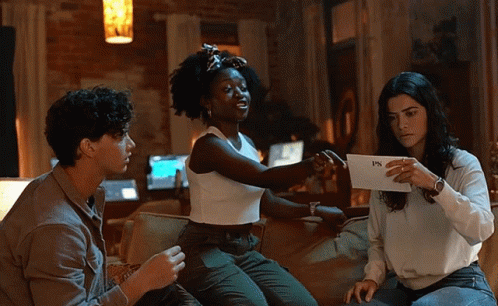 Three People on Couch Holding FPS Paper